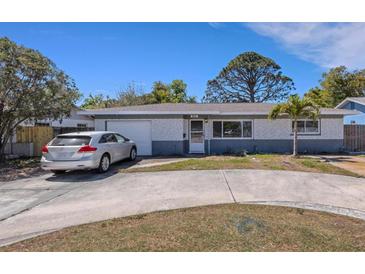 Charming single-story home with a circular driveway and well-maintained front yard at 1988 58Th N St, St Petersburg, FL 33710
