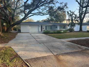 Charming single-story home with an attached garage and a well-manicured front yard at 287 Belleair Ne Dr, St Petersburg, FL 33704