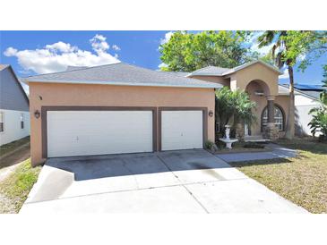 Charming home featuring a two-car garage, fountain, and inviting entryway at 9711 Wydella St, Riverview, FL 33569