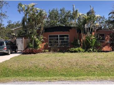 Charming single-story home with a well-manicured lawn, mature trees and a private driveway at 1465 Fundy Rd, Venice, FL 34293