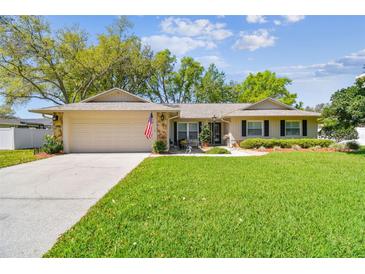 Charming single-story home with a well-manicured lawn, stone accents and attached two car garage at 3952 Applegate Cir, Brandon, FL 33511