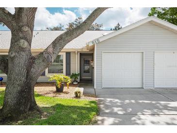 Charming single-story home featuring a one-car garage, well-kept lawn, and delightful curb appeal at 39650 Us Highway 19 N # 615, Tarpon Springs, FL 34689