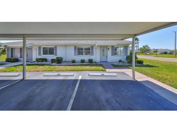 Charming single-story home with a covered parking area and well-maintained landscaping at 124 Gloucester Blvd # 355J, Sun City Center, FL 33573