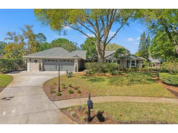 Charming one-story home featuring a landscaped front yard and a spacious two-car garage at 20315 Mid Ct, Lutz, FL 33558