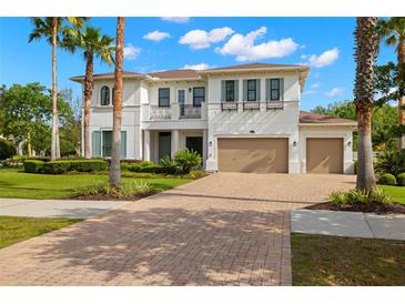 Stunning two-story home featuring a brick driveway, lush landscaping, and an attached two-car garage at 3226 Cordoba Ranch Blvd, Lutz, FL 33559