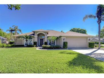 Charming single-story home with a well-manicured lawn, mature landscaping, and a spacious two-car garage at 4904 Breyer Wood Ct, Valrico, FL 33596