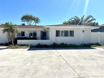 Charming one-story home with a white brick facade and well-lit front at 121 175Th E Ave, Redington Shores, FL 33708