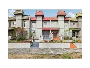 Exterior front view of townhomes with manicured landscaping and front patios at 170 E Davis Blvd, Tampa, FL 33606