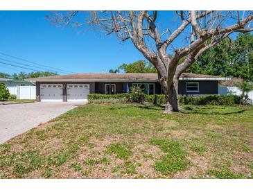 Charming single-story home featuring an attached two-car garage and a well-maintained lawn at 1828 Stancel Dr, Clearwater, FL 33764