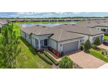 Beautiful single-story home with a brick driveway and a serene water view, located in a desirable community at 19212 Iron Topsail Isle, Land O Lakes, FL 34638