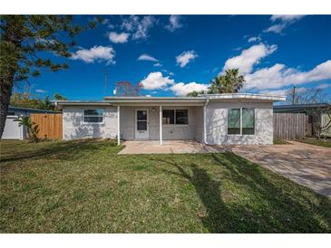 Charming single-story home featuring a well-maintained lawn and a cozy front porch area at 5411 96Th N Ter, Pinellas Park, FL 33782