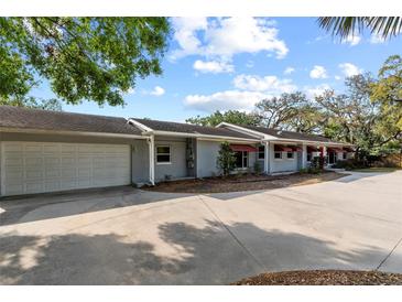 Home exterior view showing a two-car garage and a curved driveway at 705 S West Shore Blvd, Tampa, FL 33609