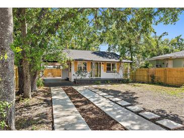 Charming single story home featuring a covered driveway, minimalist front yard landscaping, and a quaint front porch at 828 20Th S Ave, St Petersburg, FL 33705