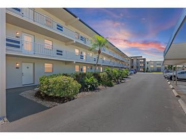 Condo building with well-maintained landscaping and ample parking at 9940 47Th N Ave # 210, St Petersburg, FL 33708