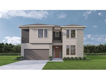 Charming two-story home featuring a well-manicured lawn, a two-car garage, and a welcoming front door at 3319 W Marlin Ave, Tampa, FL 33611