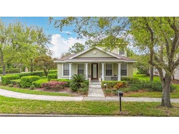 Charming single-story home featuring a well-manicured lawn and inviting front porch with classic columns at 6002 Churchside Dr, Lithia, FL 33547