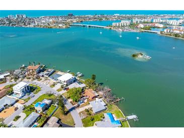 Gorgeous waterfront homes with boat docks line this scenic aerial view of the beautiful bay and its calm, turquoise waters at 7160 S Shore S Dr, South Pasadena, FL 33707