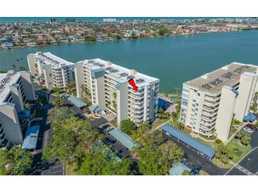 Aerial view of waterfront condos with covered parking and lush landscaping near the waterway at 7932 Sailboat Key S Blvd # 806, South Pasadena, FL 33707