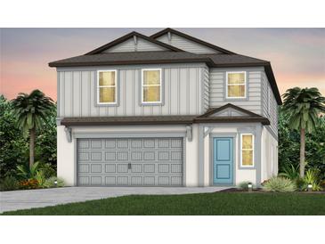 Charming two-story home with a gray garage door, board and batten siding, and a blue front door at 9763 Crescent Moon Dr, Riverview, FL 33578