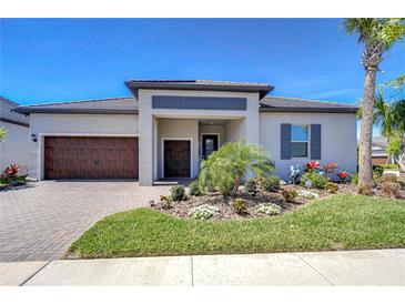 Charming single-story home with well-manicured lawn, brick driveway, and vibrant landscaping at 31452 Cabana Rye Ave, San Antonio, FL 33576
