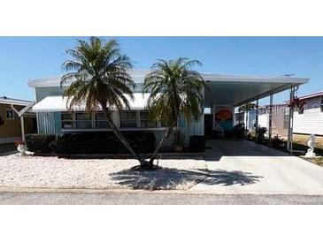 Charming single-story home with a carport, palm trees, and well-kept landscaping in a quiet neighborhood at 665 54Th S St # 133, Gulfport, FL 33707