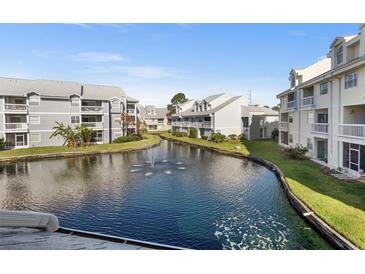 Water view of community with waterway and multi-story condo buildings under a blue sky at 6923 Stones Throw N Cir # 4205, St Petersburg, FL 33710