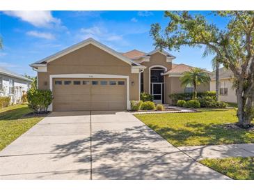 Charming single-Gathering home with a well-manicured lawn and an attached two-car garage in a suburban neighborhood at 7140 Maysville Ct, Wesley Chapel, FL 33545