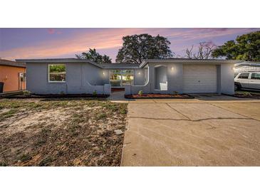 Charming single-story home with a well-maintained exterior and a large driveway at 7814 Chalafonte Dr, Port Richey, FL 34668