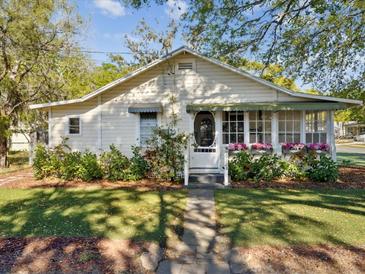 Charming home with a well-manicured lawn and flower boxes creating a welcoming curb appeal at 6228 Monroe St, New Port Richey, FL 34653