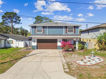 Charming two-story home featuring a well-maintained lawn and an attached garage at 6680 67Th N Way, Pinellas Park, FL 33781
