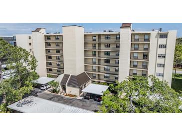 Multi-story condo complex featuring covered parking and beautifully landscaped surroundings at 2700 Cove Cay Dr # 5-G, Clearwater, FL 33760