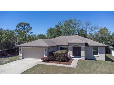 Charming single-story home featuring an attached two-car garage and well-maintained landscaping at 6527 Grapewood Rd, Spring Hill, FL 34609