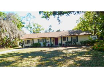 Charming single-story home with well-manicured lawn and mature trees in a peaceful residential setting at 908 N Knight St, Plant City, FL 33563