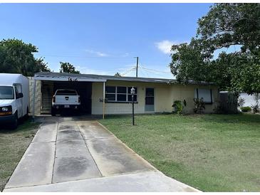 Charming single-story home with a well-maintained lawn and covered parking in a suburban neighborhood at 1606 Marilyn Ave, Bradenton, FL 34207