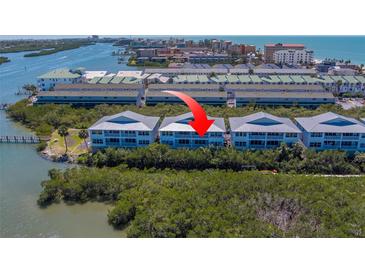 Beautiful aerial view of waterfront condos with water access and lush landscaping at 19829 Gulf Blvd # 601, Indian Shores, FL 33785