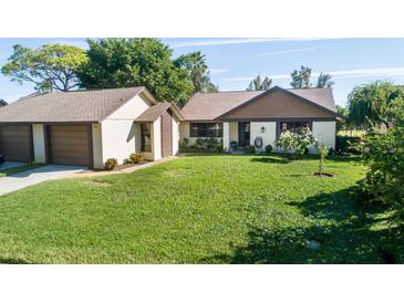 Charming single-story home with a well-manicured lawn and attached two-car garage, exuding curb appeal at 2254 Sequoia Dr, Clearwater, FL 33763