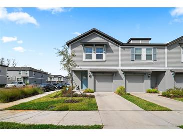 Charming two-story townhome with gray siding and a well-manicured front lawn at 2760 Scarlet Bay Pl, Brandon, FL 33510