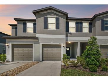 Charming townhome with well-maintained landscaping, two-car garage, and neutral color scheme at 3629 Bellmeade Ct, Wesley Chapel, FL 33543