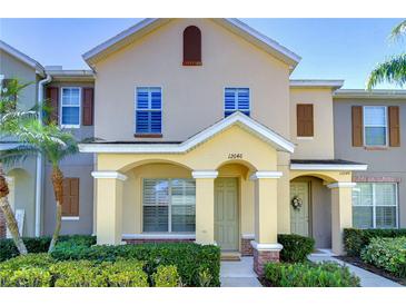 Inviting townhouse featuring a covered entry with decorative columns and lush landscaping at 12646 Carlby Cir, Tampa, FL 33626