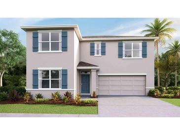 Charming two-story home with blue shutters, a two-car garage, and manicured landscaping at 35138 Valley Ridge Rd, Dade City, FL 33525