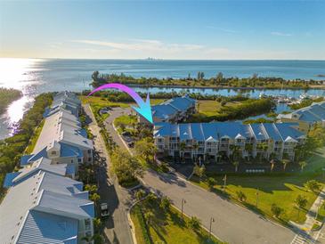 Aerial view of waterfront condos boasting boat docks and stunning water views of the bay and the city skyline at 418 Bahia Beach Blvd, Ruskin, FL 33570