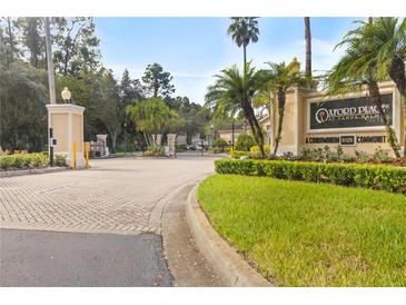 Gated community entrance featuring lush landscaping, mature trees, and prominent signage at 5125 Palm Springs Blvd # 11306, Tampa, FL 33647