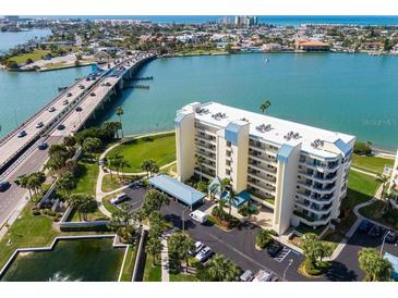 An aerial view of a condo complex in a coastal setting, with a bridge and palm trees nearby at 7862 Sailboat Key S Blvd # 103, South Pasadena, FL 33707