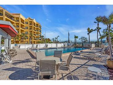 Inviting in-ground pool with an outdoor seating area and lounging chairs, perfect for relaxing at 10301 Gulf Blvd # 302, Treasure Island, FL 33706