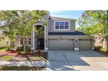 Beautiful two story home featuring a three car garage and well-manicured landscaping at 10818 Breaking Rocks Dr, Tampa, FL 33647