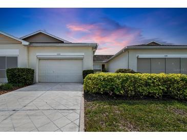 Charming single-story villa showcasing a well-maintained exterior, driveway, and manicured landscaping at 1120 Radison Ave # 6, Sun City Center, FL 33573