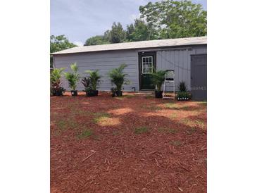 Metal clad structure with green door and decorative plants at 16251 Us Highway 301, Dade City, FL 33523