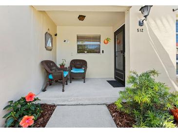 Inviting front porch with comfortable wicker chairs and tasteful nautical decor at 2700 Bayshore Blvd # 512, Dunedin, FL 34698