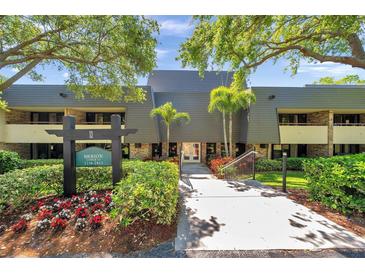 Attractive building exterior with mature landscaping and easy access to all units at 36750 Us 19 N # 2763, Palm Harbor, FL 34684