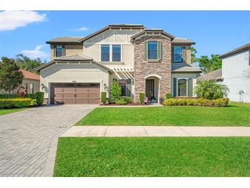 Charming two-story home with stone accents, well-manicured lawn, and inviting curb appeal at 16532 Ballyshannon Dr, Tampa, FL 33624